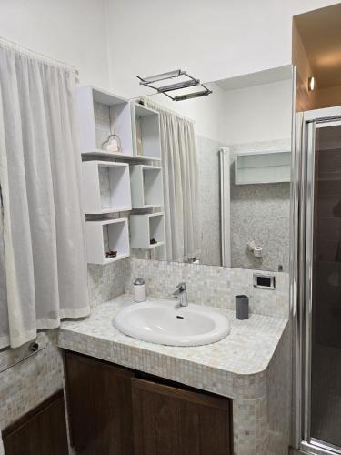 a bathroom with a sink and a mirror at Bis Jolly 1 in Cosenza