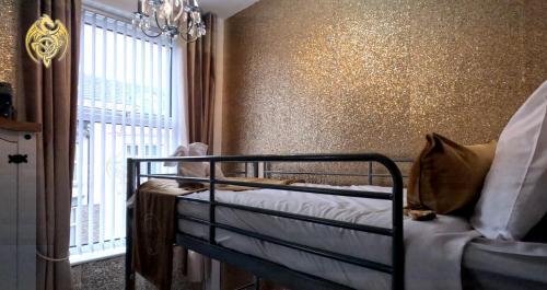 a bedroom with a crib in a room with a window at The Celtic Pride Hotel in Blackpool