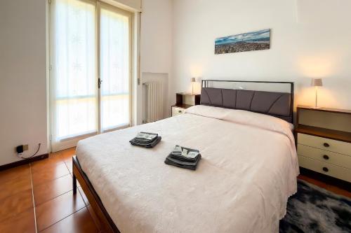 a bedroom with a large bed with two glasses on it at Viewpoint House in Alzano Lombardo