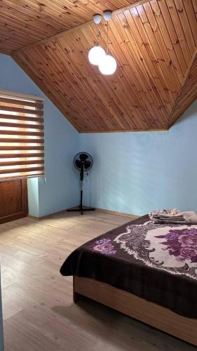 a bedroom with a bed and a wooden ceiling at Villa Nabran in Nabran
