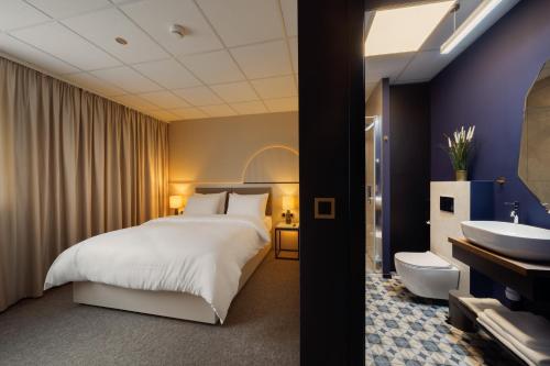 a hotel room with a bed and a sink at Yuko Residence in Jasło