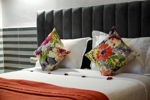 two pillows sitting on top of a bed at Riad Allal in Marrakesh