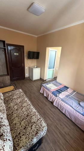 a hotel room with two beds and a tv at Motel Ararat in Rava-Rusʼka