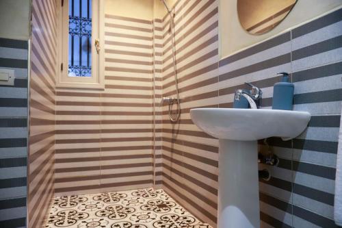 a bathroom with a sink and a shower at Riad Allal in Marrakesh