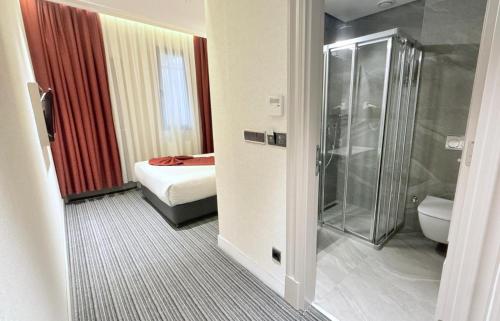 a bathroom with a shower and a bed and a toilet at Union Hotel Plat Inn -Special Category in Istanbul
