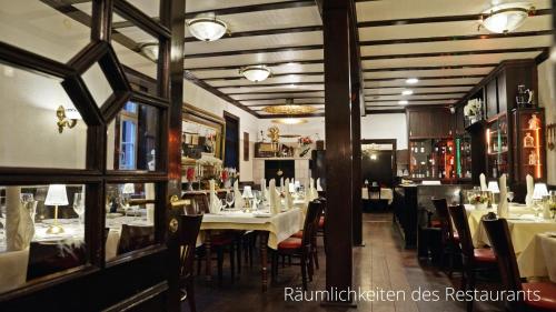 a dining room with tables and chairs in a restaurant at Das Lamm Heidelberg in Heidelberg