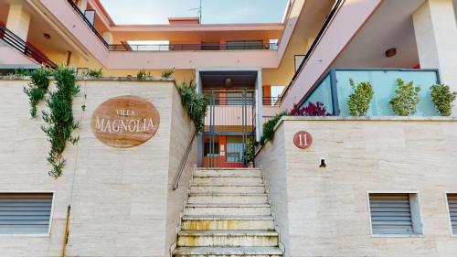 a stairway leading to the entrance of a hotel at Residence Magnolia in Grado