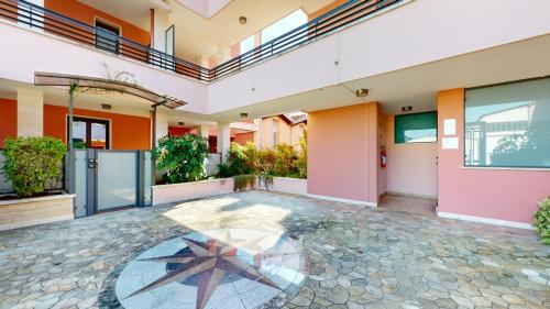 a courtyard of a building with a star on the floor at Residence Magnolia in Grado