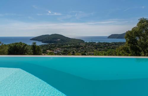 a swimming pool with a view of the ocean at Villa di Sogno in Palazzo
