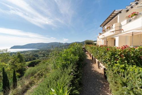 a house on a hill with a row of plants at Villa di Sogno in Palazzo
