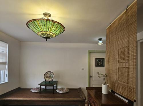 a large chandelier hanging from the ceiling in a room at Farm Cottage in Hong Kong