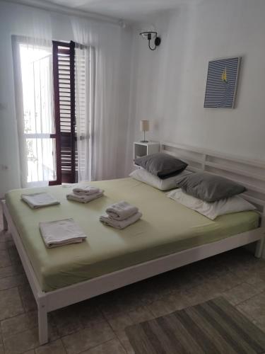a bedroom with a large bed with towels on it at Apartments Tamaris in Zaostrog