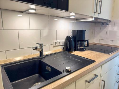 a kitchen with a sink and a coffee maker at Strandvilla Therese Appartment 5 in Norderney