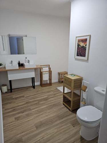a bathroom with a toilet and a sink at The Yellow Cottage in Lomba de São Pedro