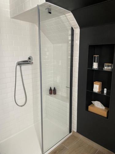 a shower with a glass door in a bathroom at Le Clos d Emilie in Saint-Marcel