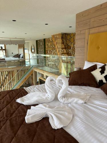 a swan made out of white sheets on a bed at Loft Chalet Bansko in Bansko