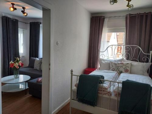 a bedroom with a bed and a living room at Apartmenthaus Schlosspark in Worms