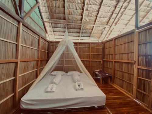 a room with three elephants laying on a bed at Isiie Homestay in Merpati