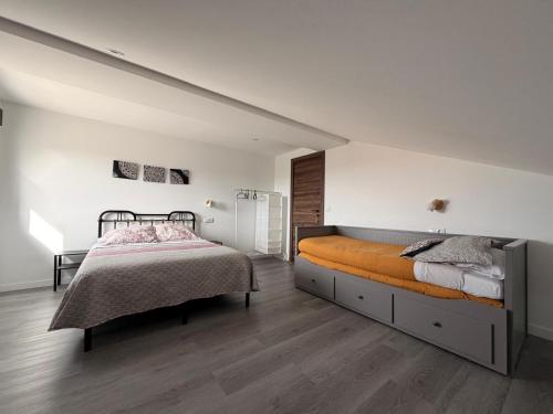 a bedroom with a large bed and white walls at Campos de Villalba in Villalba