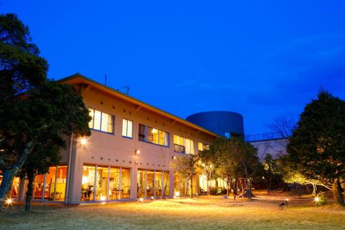 a large building at night with a building at Hotel Tokinoza in Kihokucho