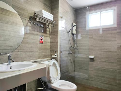 a bathroom with a toilet and a sink and a shower at โคโค่ โฮเทล KOCO Hotel in Nakhon Ratchasima