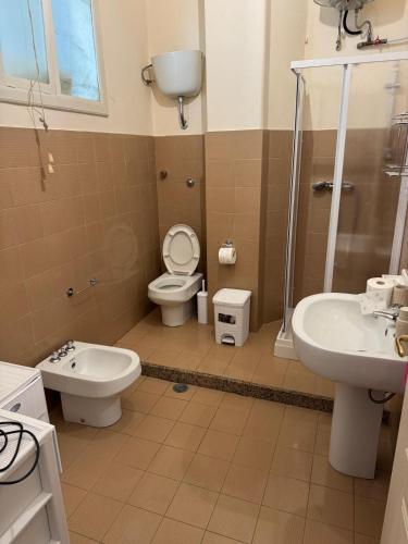 a bathroom with a toilet and a sink and a shower at SuiteMazzini in Lamezia Terme