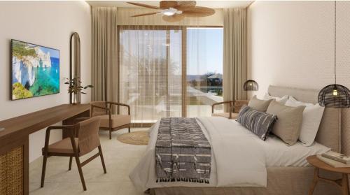 a bedroom with a bed and a desk with a desk at Agali Hotel Milos in Adamantas