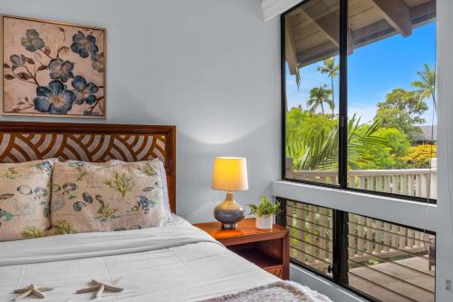 a bedroom with a bed and a large window at Grand Champions 124 · GC 124 3BD Wailea Condo wAC Pool Hot Tub in Wailea