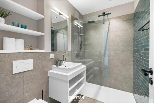 a bathroom with a white sink and a shower at Ferienwohnung TheViewB17 Boje 17 Dagebüll in Dagebüll