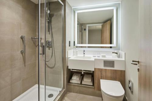 a bathroom with a toilet and a sink and a shower at Courtyard by Marriott Sheffield in Sheffield