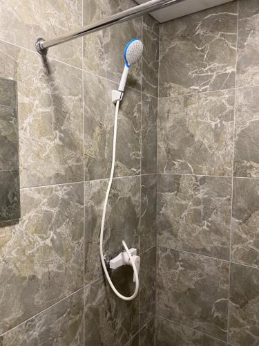 a shower with a shower head in a bathroom at Hotel Elena Solotvino in Solotvyno