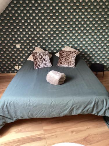 a bed in a room with a wall at Chez Nathou in Janzé