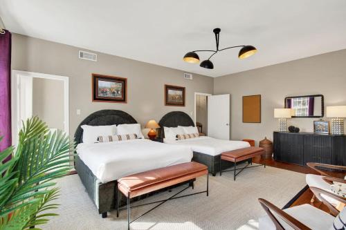 a bedroom with two beds and a table at Oglethorpe Estate in Savannah