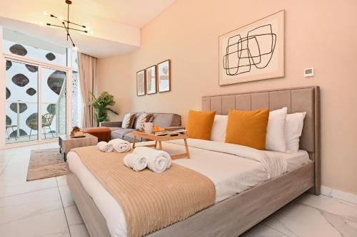 a bedroom with a large bed with towels on it at Stylish Escape with Balcony, Canal and Burj Khalifa Views Near Dubai Mall in Dubai