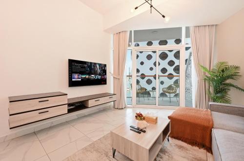 a living room with a couch and a tv at Stylish Escape with Balcony, Canal and Burj Khalifa Views Near Dubai Mall in Dubai