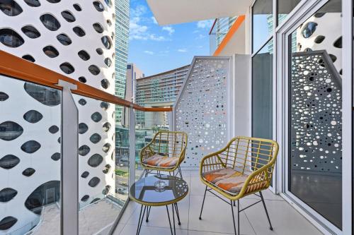 two chairs and a table on a balcony at Stylish Escape with Balcony, Canal and Burj Khalifa Views Near Dubai Mall in Dubai