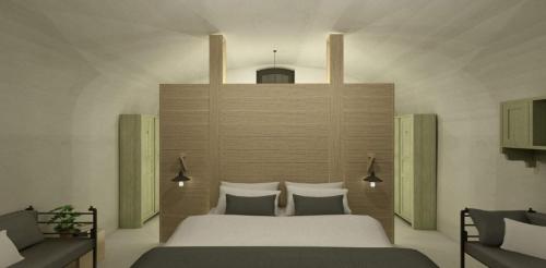 a bedroom with a large white bed at Erflogies Fort Liezele in Puursheide