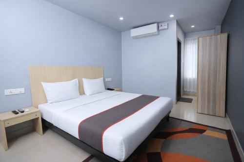 a bedroom with a large bed in a room at RJB Grand in Guwahati