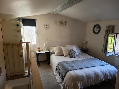 a bedroom with a bed and a clock on the wall at Le refuge de Teddy in Solliès-Toucas