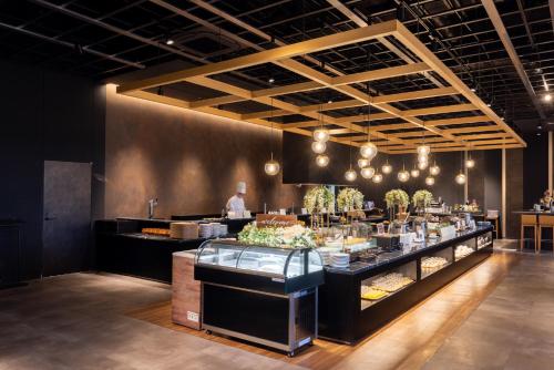 a restaurant with a counter with food on it at Tsukino HOTEL in Sakata