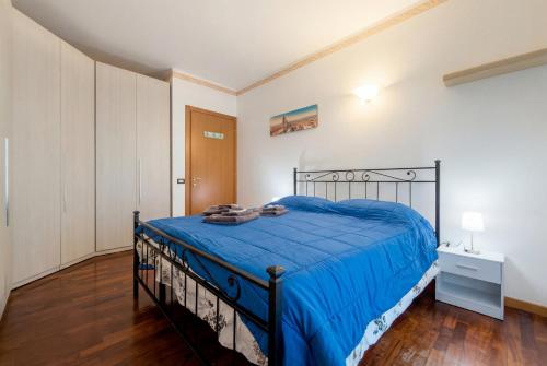 a bedroom with a bed with a blue comforter at Dreamescape House in Alzano Lombardo
