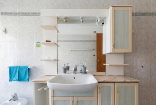 a bathroom with a sink and a mirror at Dreamescape House in Alzano Lombardo