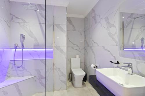 a bathroom with a sink and a toilet and a shower at 9 Montego Bay Caribbean Estates in Port Edward