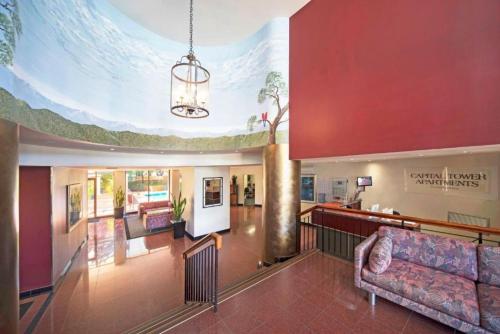 a large lobby with a couch and a chandelier at Lakefront Panorama – Sky Collection Suite in Canberra