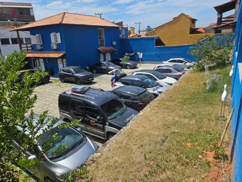 a row of cars parked in a parking lot at Pousada e Condominio Miragem Do Mar Praia Do Peró in Cabo Frio