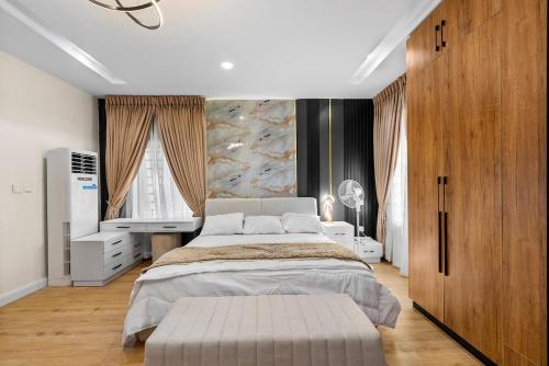 a bedroom with a large bed and a television at The Zenith Palace in Lekki