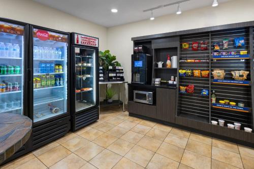 a store with two refrigerators with food and drinks at Candlewood Suites Norfolk Airport by IHG in Norfolk