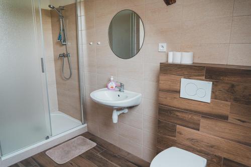 a bathroom with a sink and a shower and a toilet at Ubytování Třemešek in Šumperk