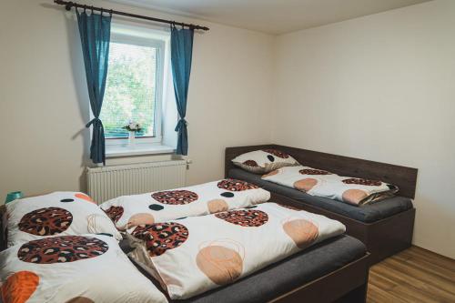 a room with three beds with basketball pillows on them at Ubytování Třemešek in Šumperk