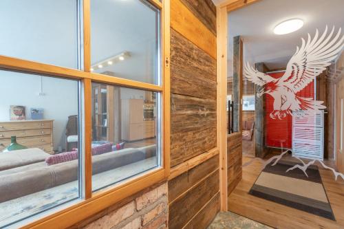 a room with a wall of windows with aulture sign on it at Roses Landhaus in Vorderhornbach